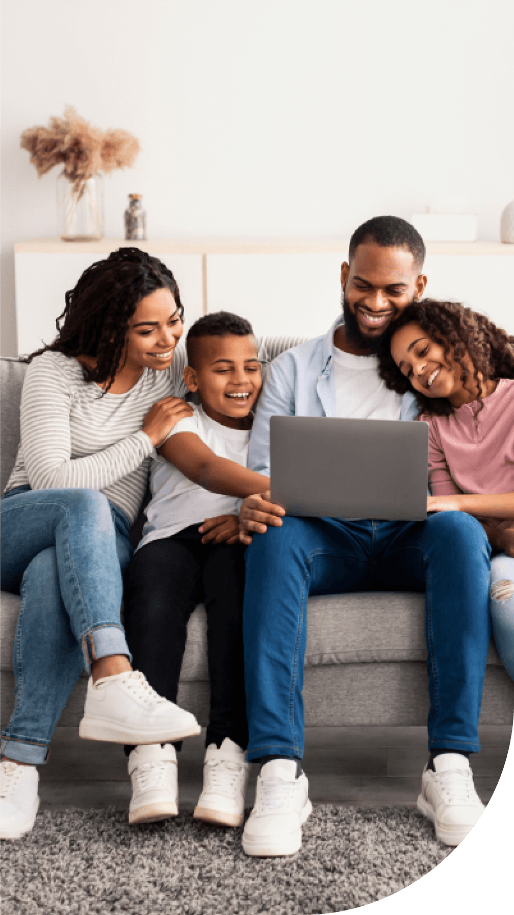 Happy family on a computer getting health advice online with TELUS Health after buying with Sonnet