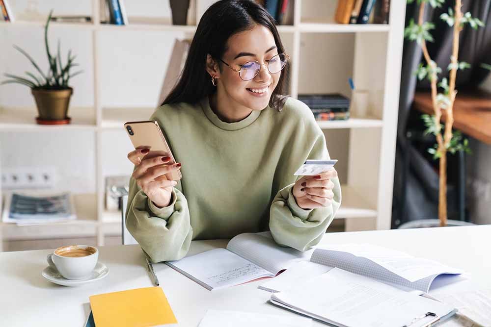 University graduate holding a credit card