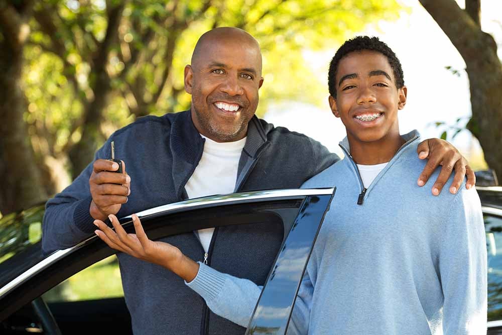 Father teaching his son how to drive