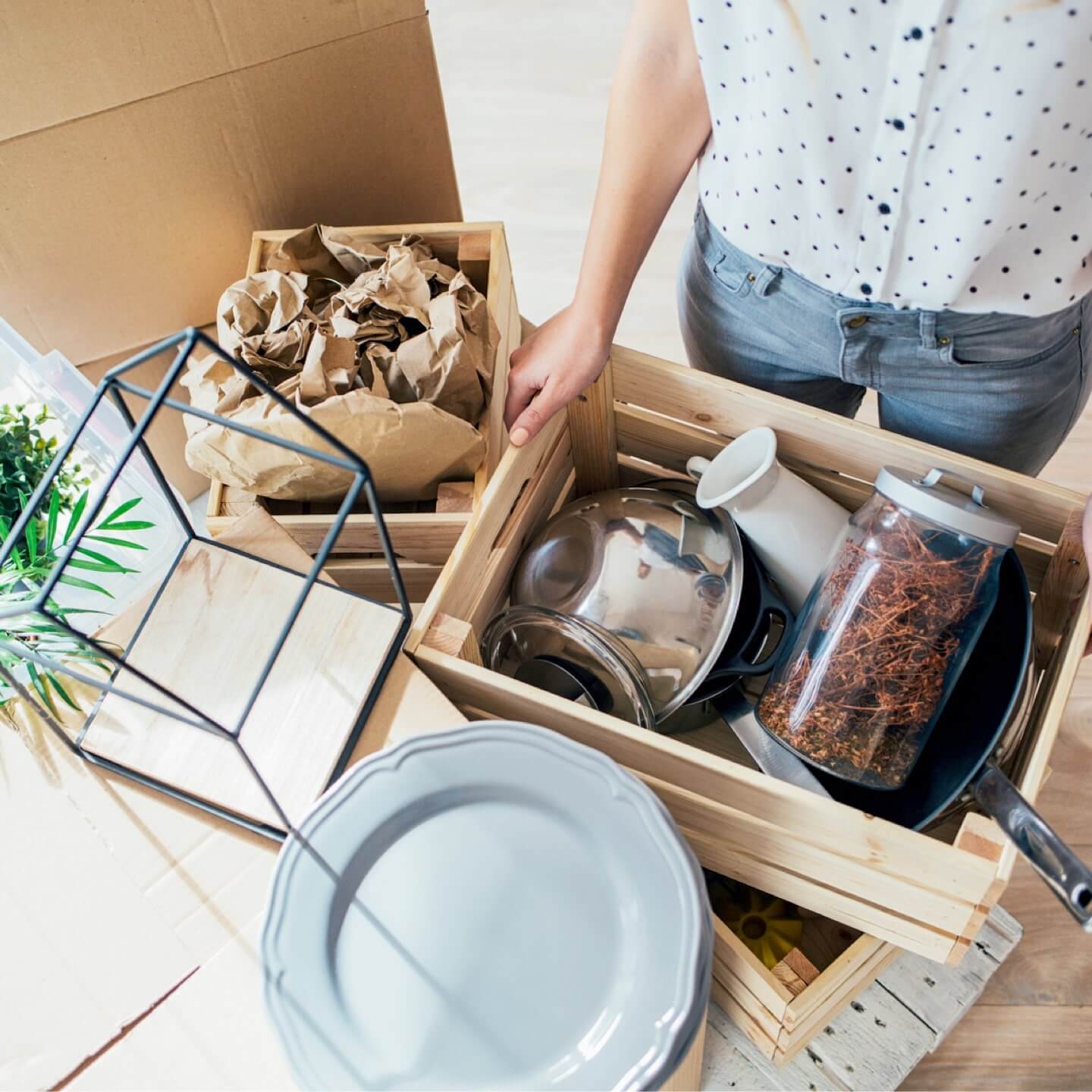 A tenant unpacking a box of insure household belongings in her condo