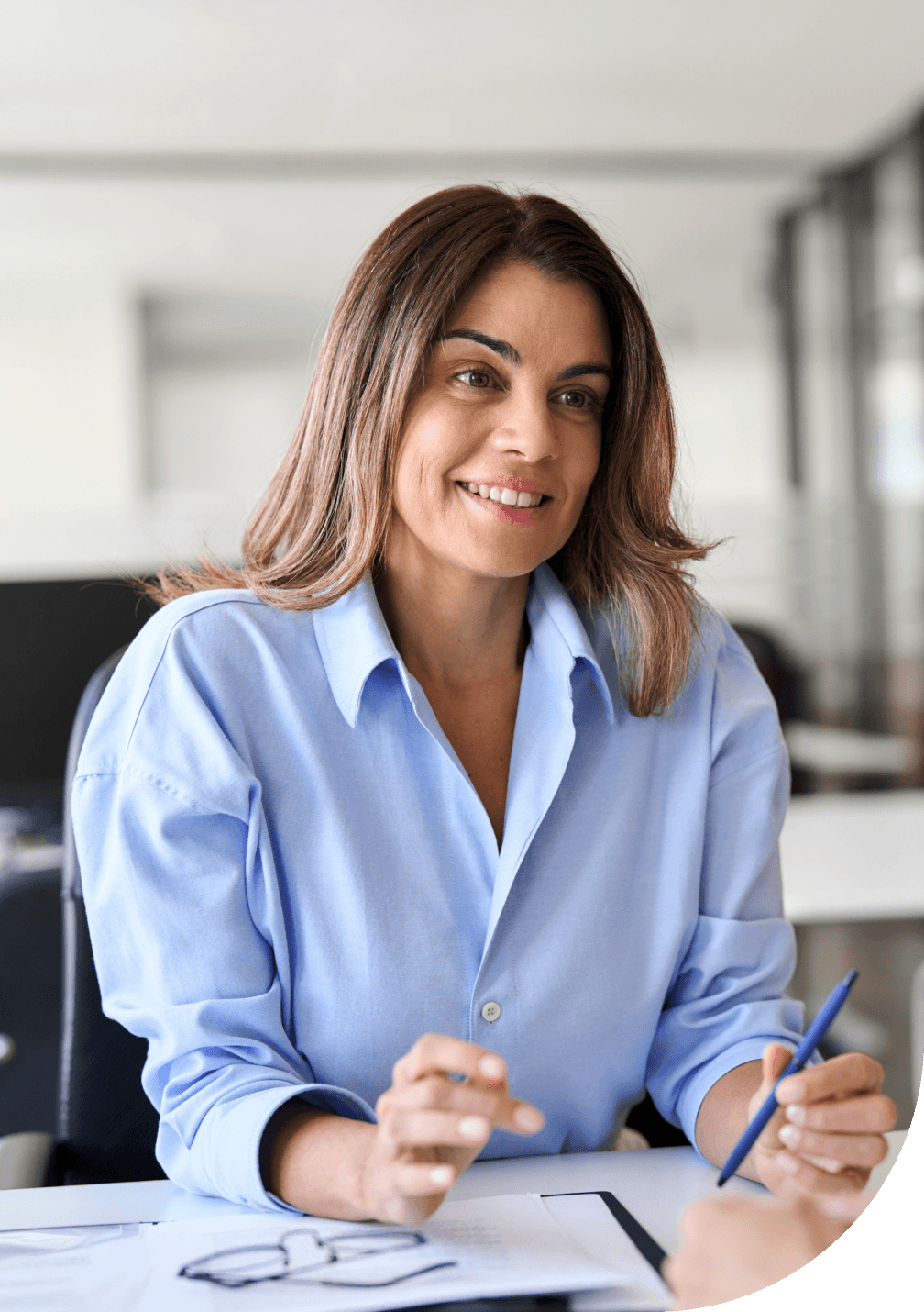 A woman sitting at a desk in an office.
