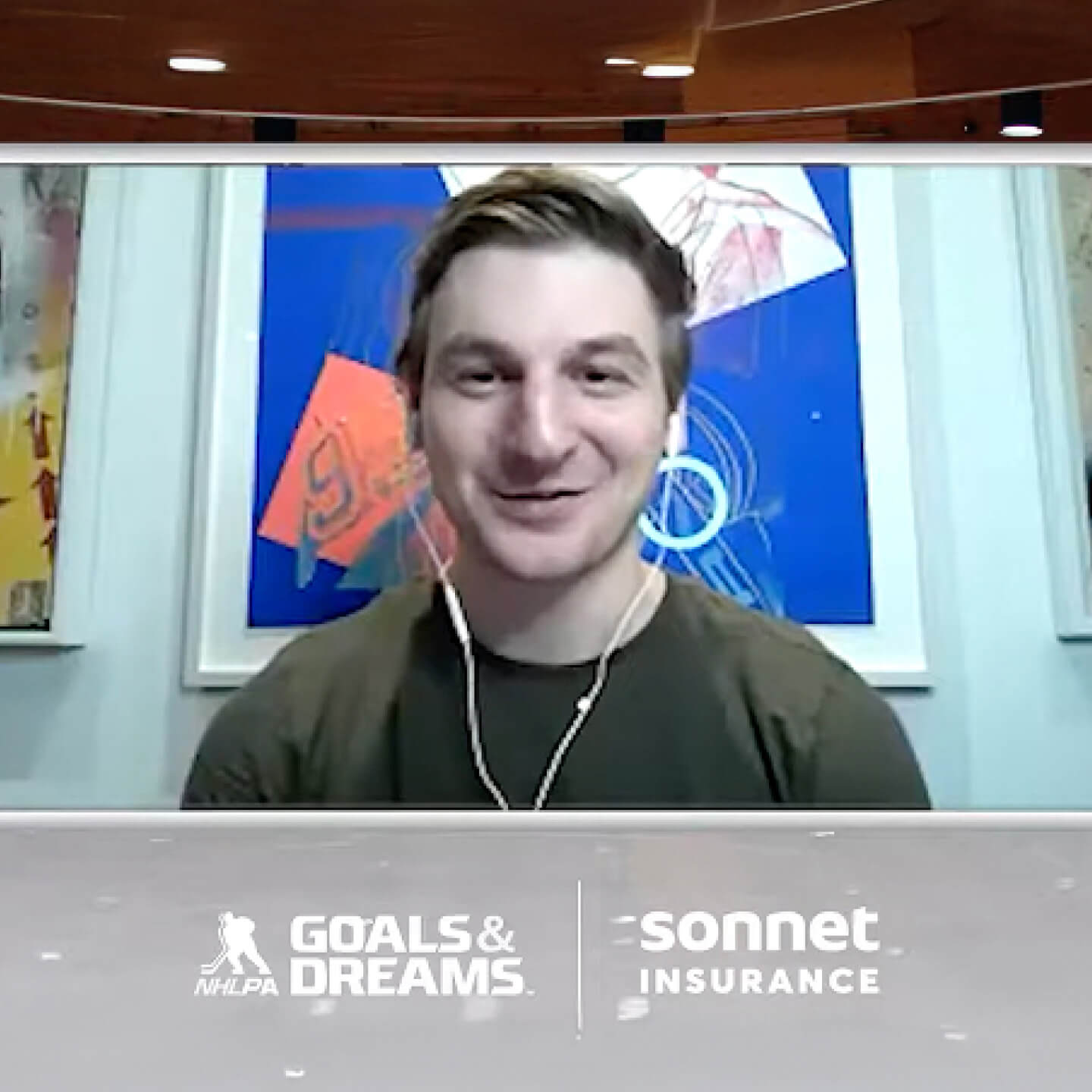 Zach Hyman of the Toronto Maple Leafs in a green shirt during a video segment with artwork in the background and text overlay featuring NHLPA Goals & Dreams and Sonnet Insurance logos.