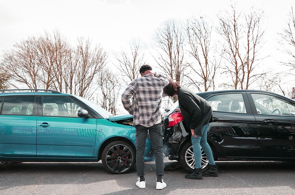 Two people looking at a fender bender