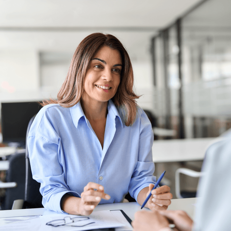 A woman sitting at a desk in an office.