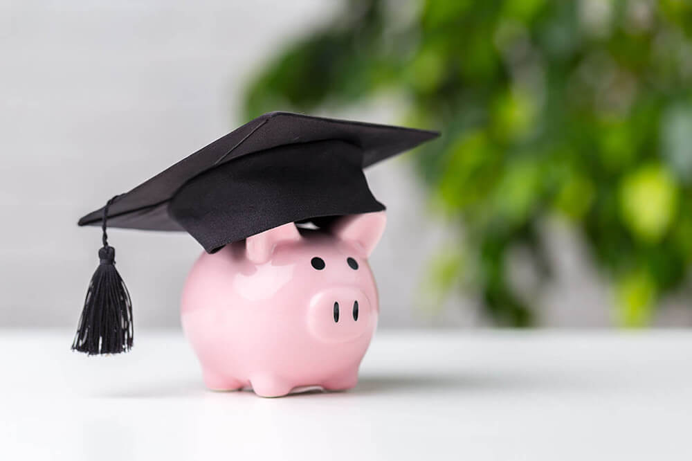 Mortar board hat on a piggy bank