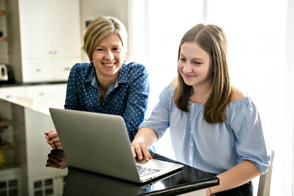 Mother teaching teenage daughter about credit score