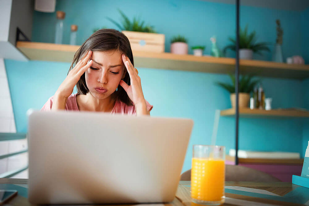Stressed young woman at work