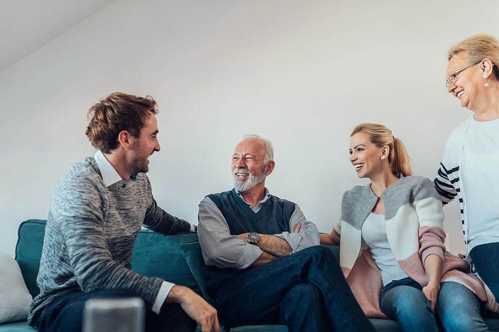 Adults talking with their elderly parents