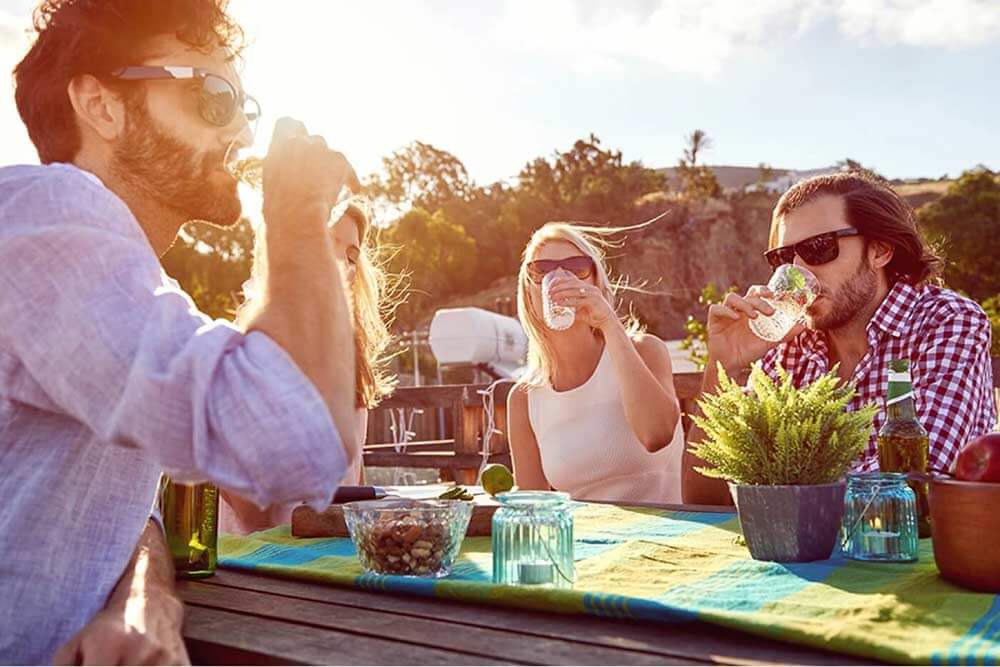 Three people drinking outside