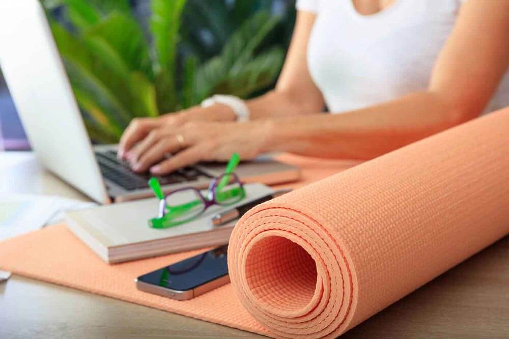 Woman and an exercise mat in an office background