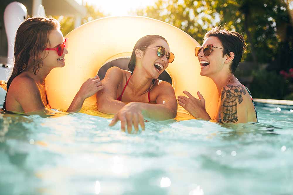 Three young women in a swimming pool