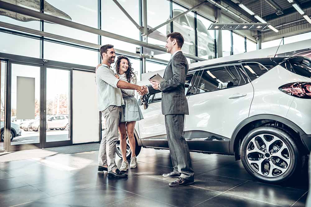 Young couple shopping for a car