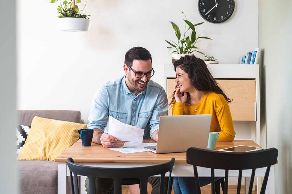 Roommates reviewing finances in the kitchen