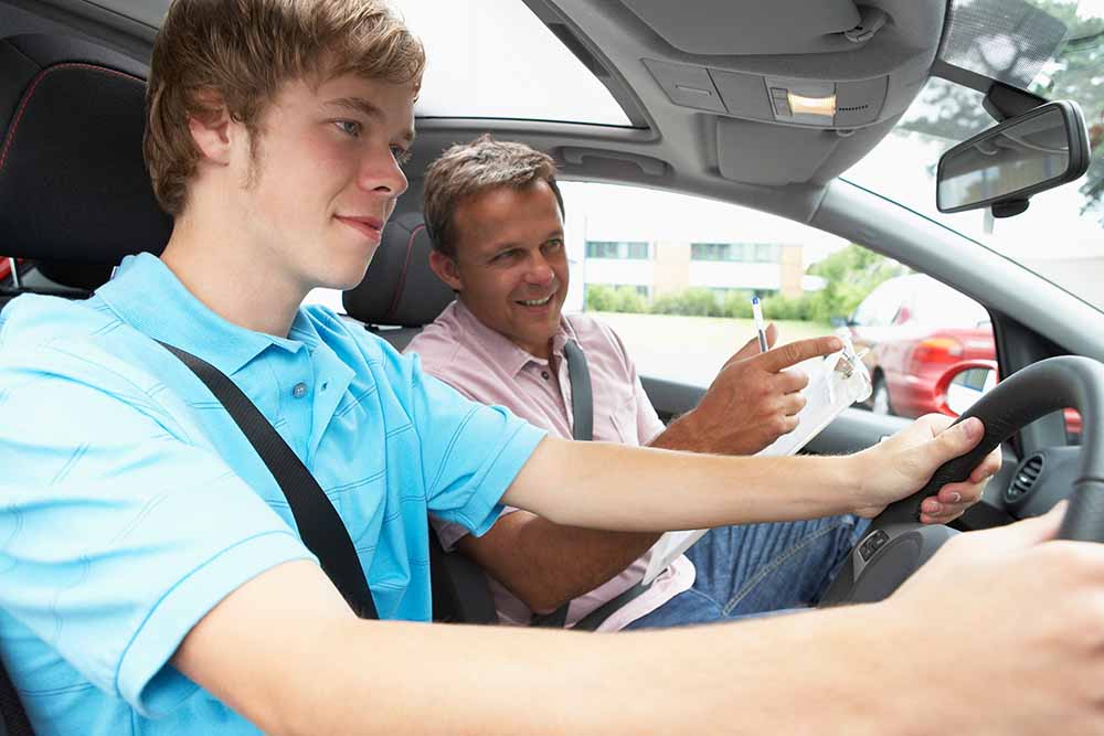 Teenage boy with a driving instructor