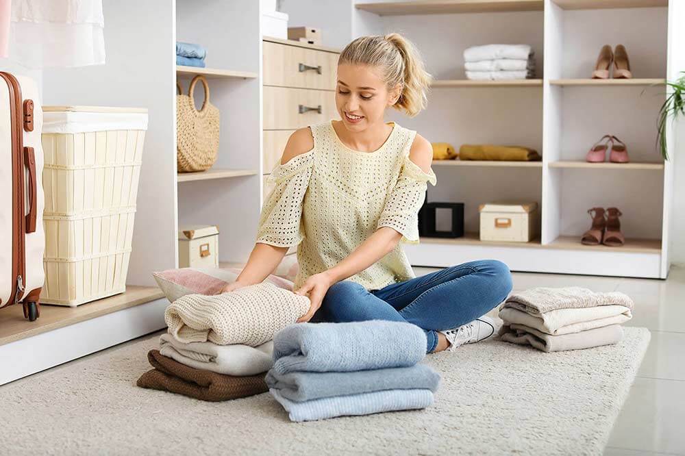 Woman folding clothes at home