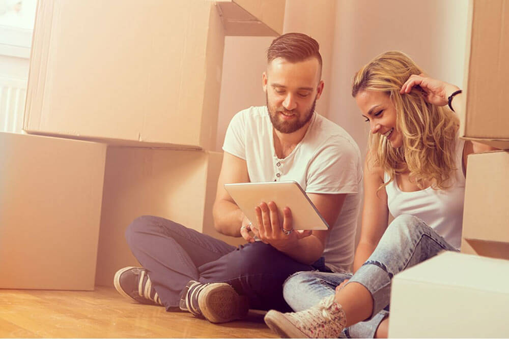 Couple moving and looking at an iPad