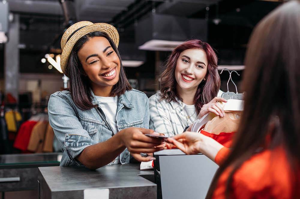 Two young women shopping at a retail store