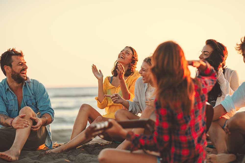 A group of friends sitting on a beach