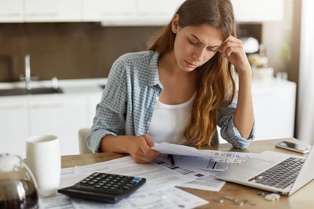 Woman looking at bills