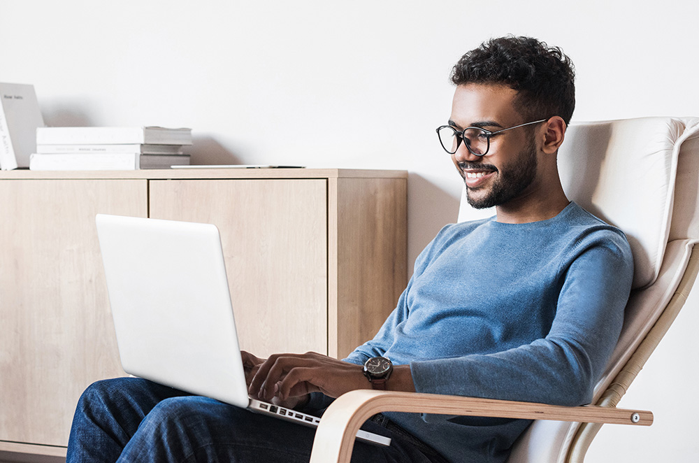 A man typing on a laptop