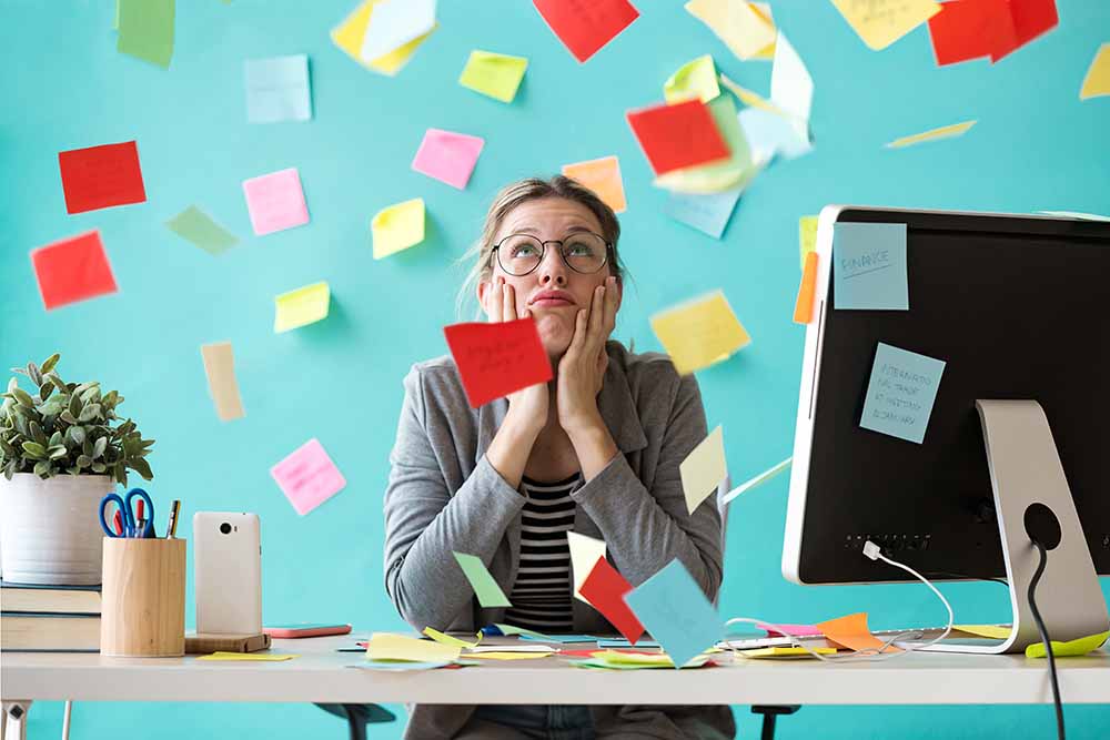 Young woman surrounded by post-it notes