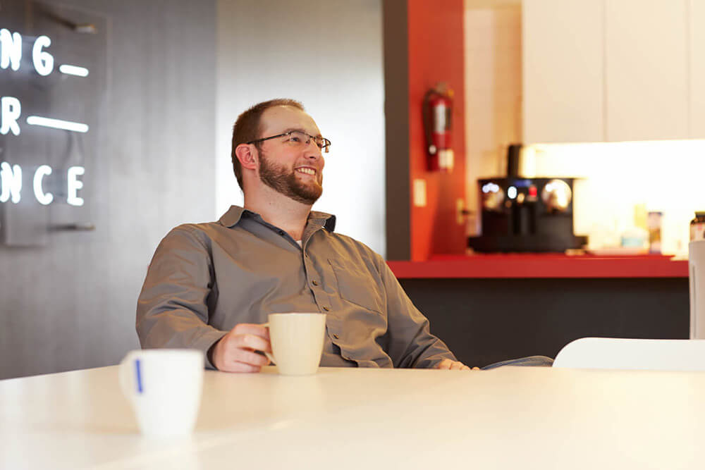 Man with coffee cup sitting at table