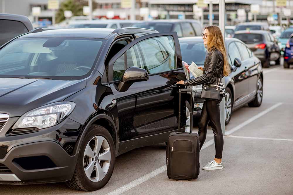 Young woman picking up a rental car