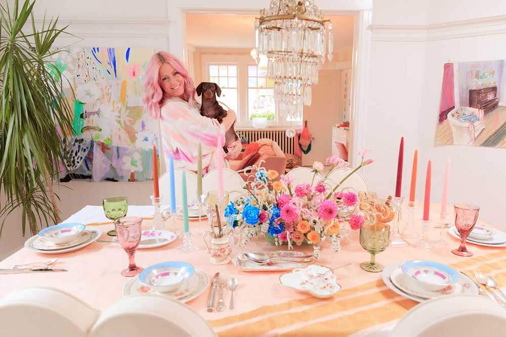 Bright and colourful dining room with Tiffany Pratt and her dog