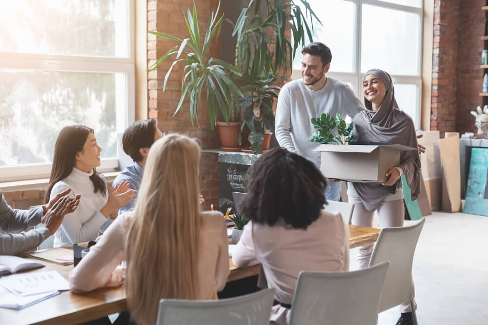 Young multiracial business team welcoming newcomer woman in hijab