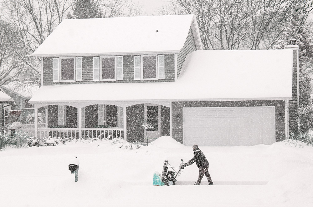 A man using a snowblower