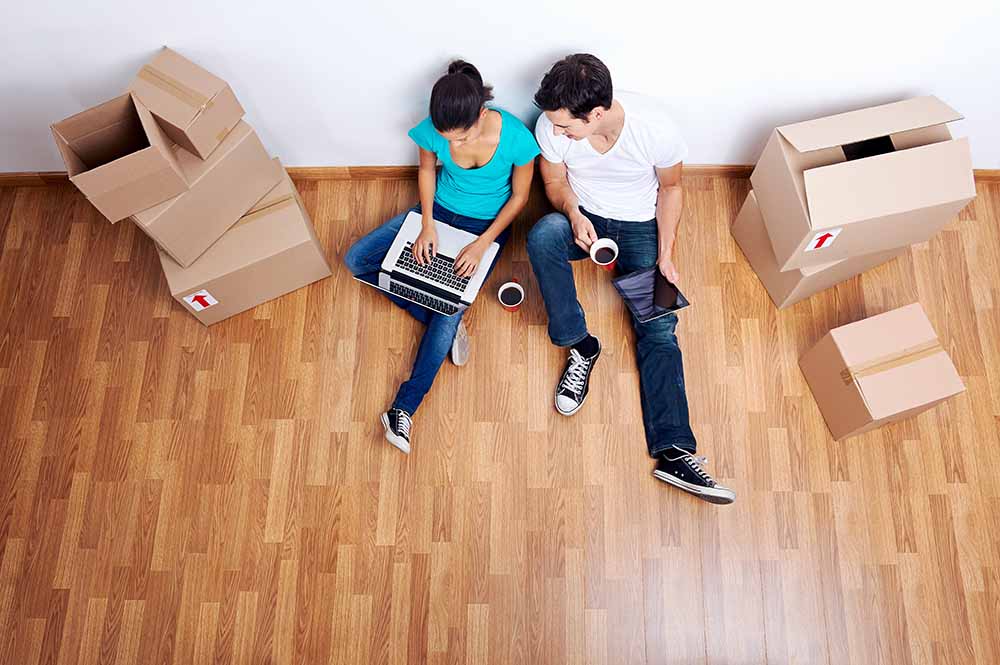 Young couple sitting in new condo