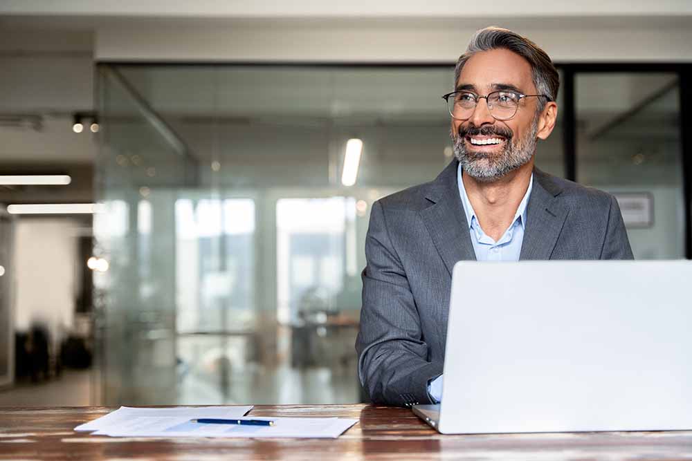 Older man working at a computer in an office