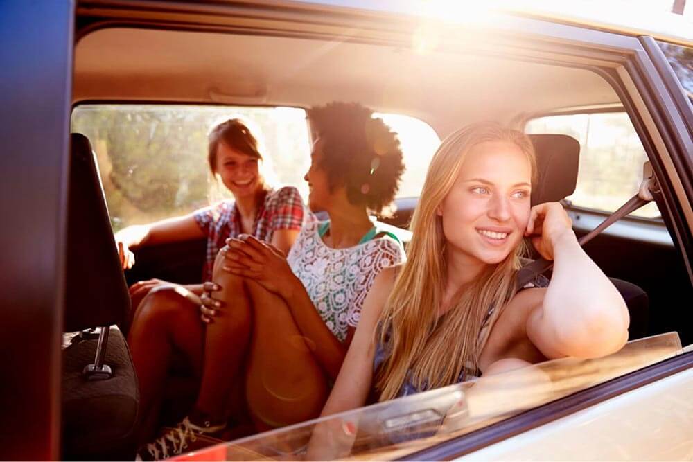 Group of girlfriends in the back seat of a car