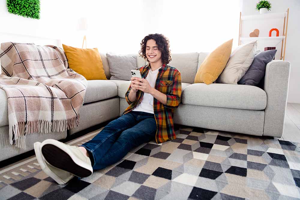 Young man sitting in a condo