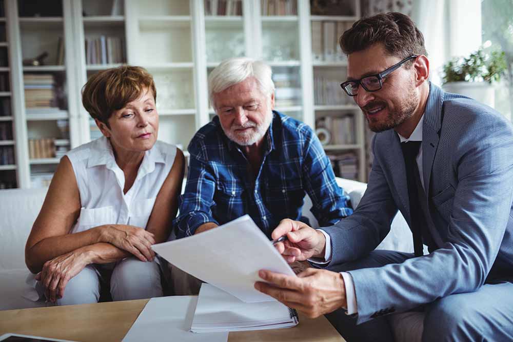 Senior couple planning their investments with a financial advisor