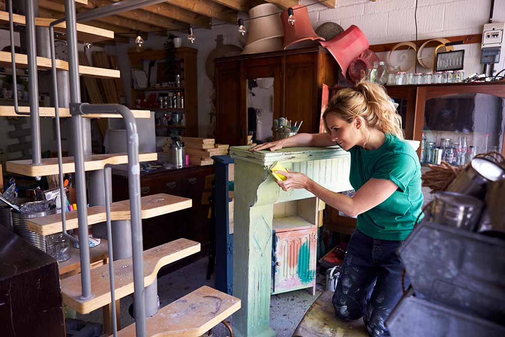 Woman upcycling old furniture