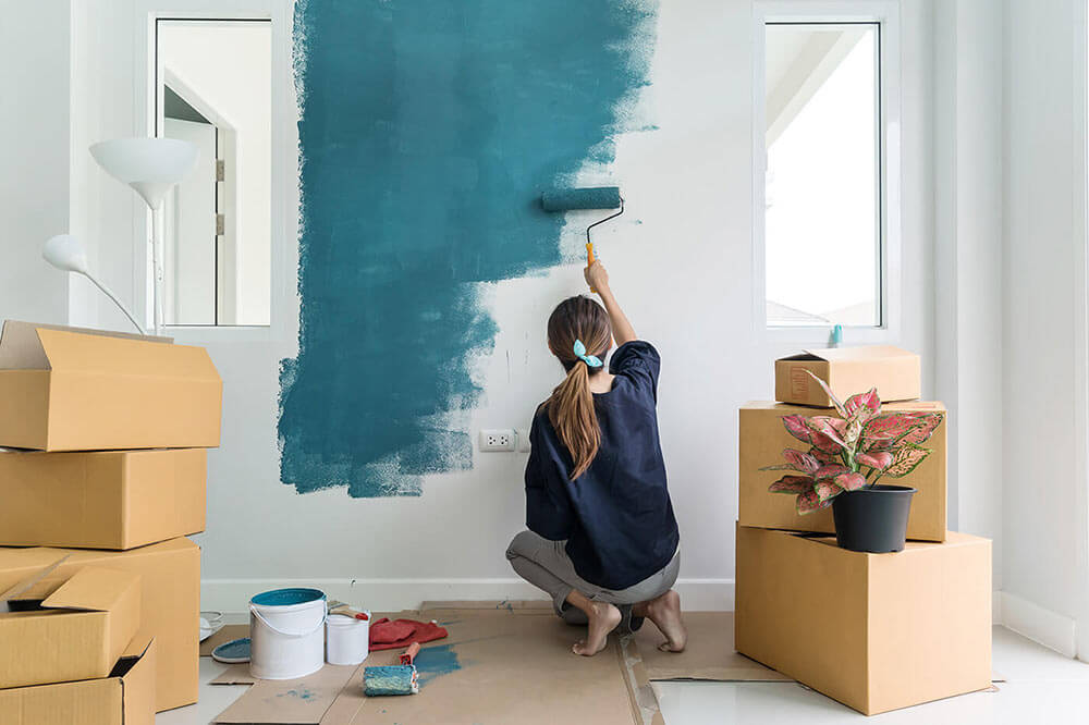 Woman painting a wall