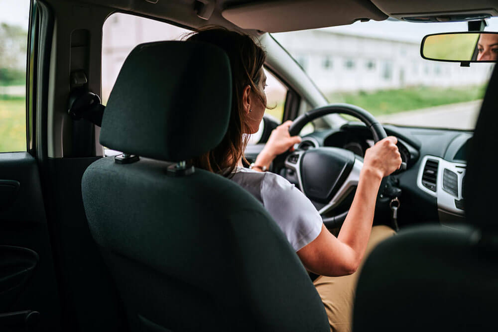 Woman driving a borrowed car