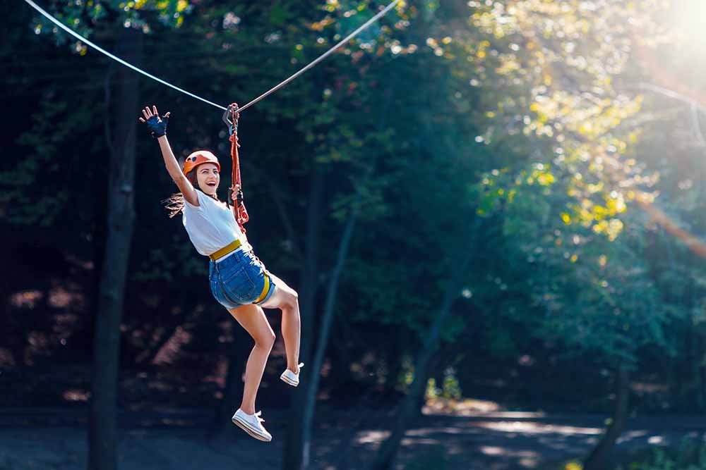 Woman ziplining in the forest