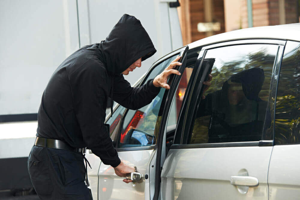 Thief burglar at automobile car stealing
