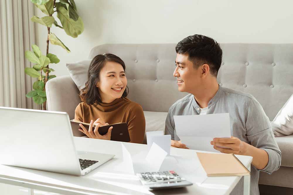 Young couple sitting at a laptop