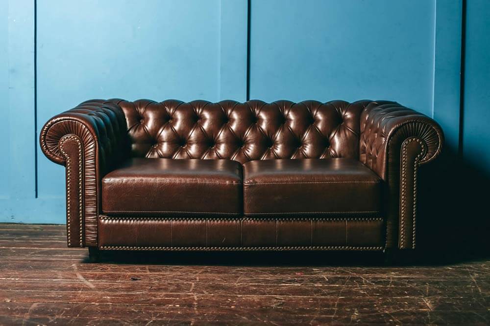 Expensive Italian leather couch being evaluated for actual cash value