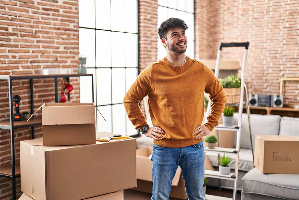 Young man moving into an apartment