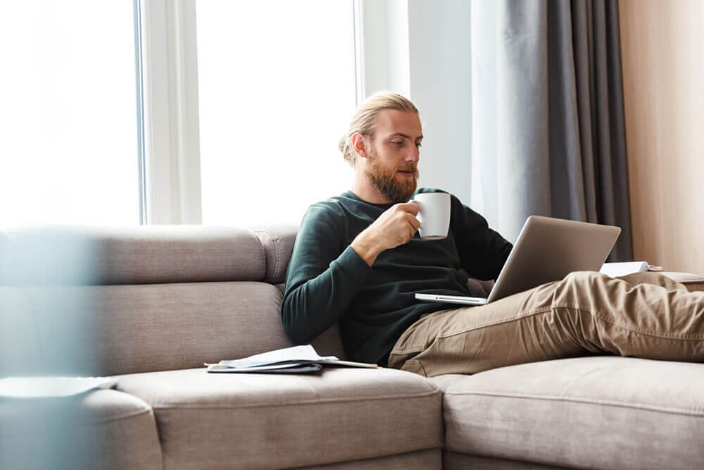 Young man reviewing his insurance policy on his laptop