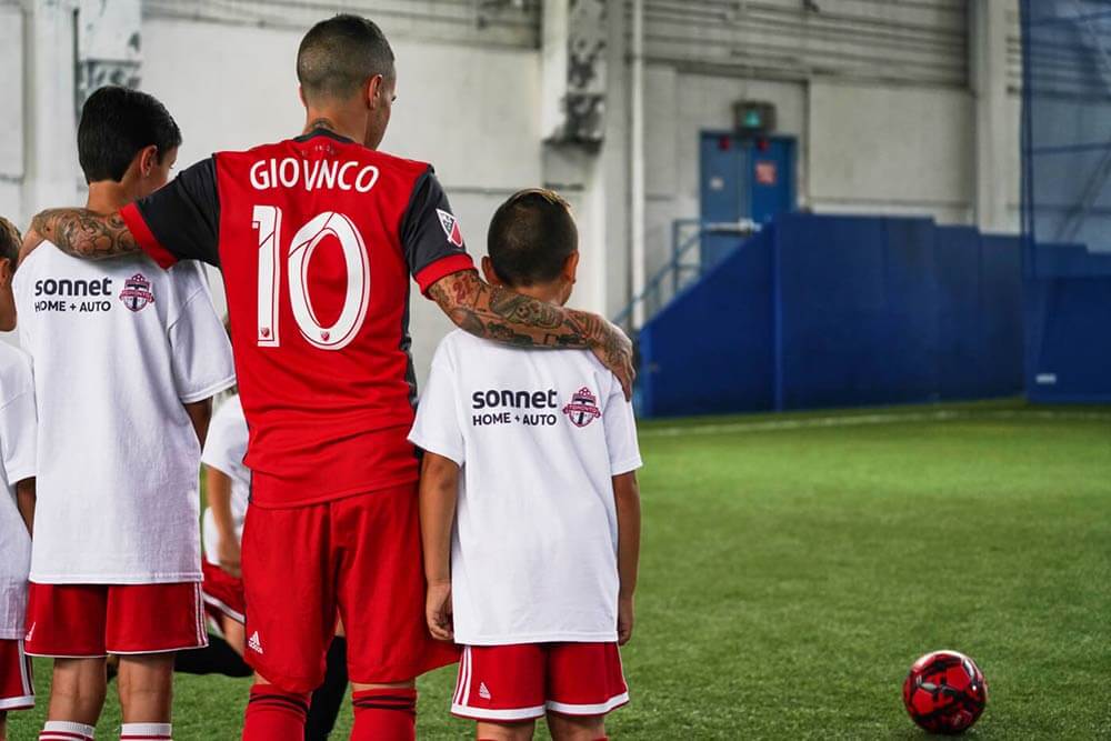 TFC player Giovinco with kids playing soccer