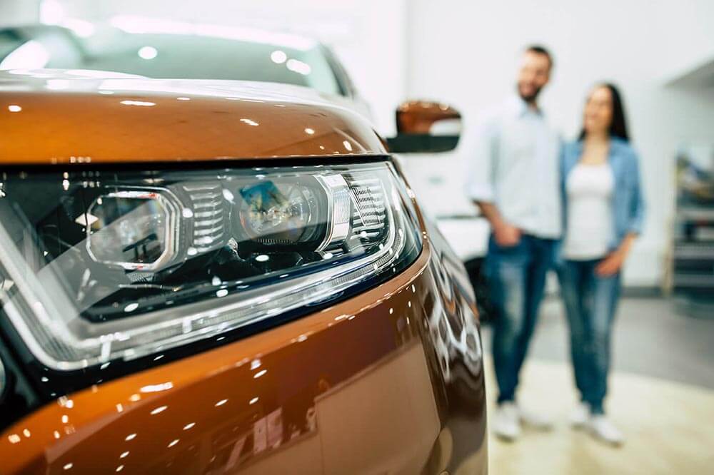 Young couple with car