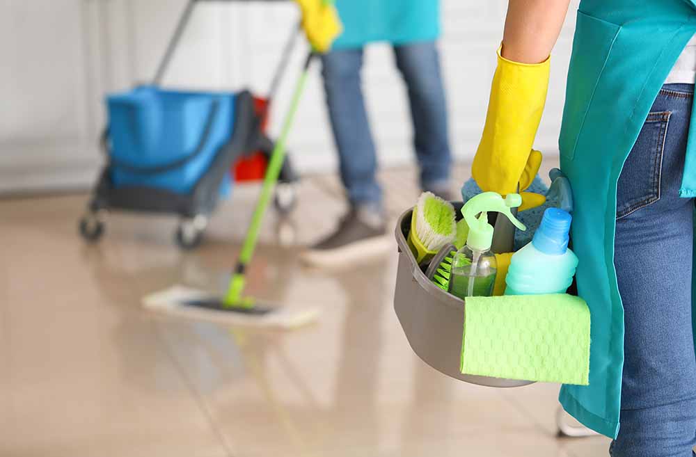 A man and a woman cleaning a home