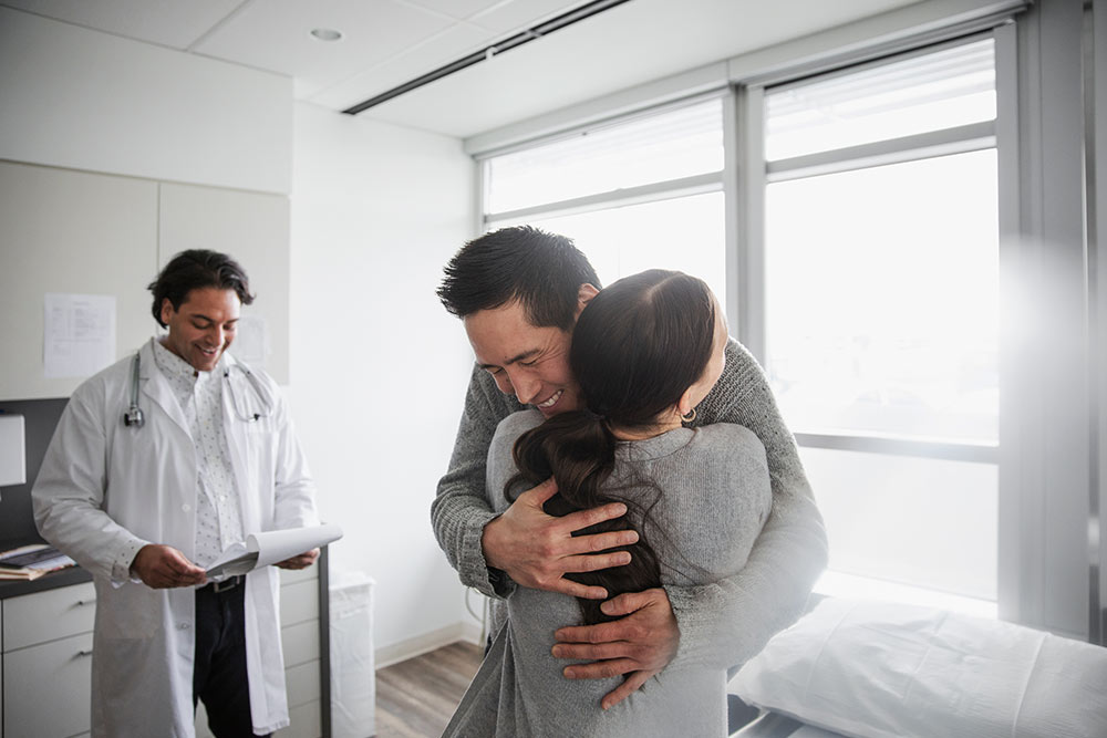 Couple embracing at doctor's office