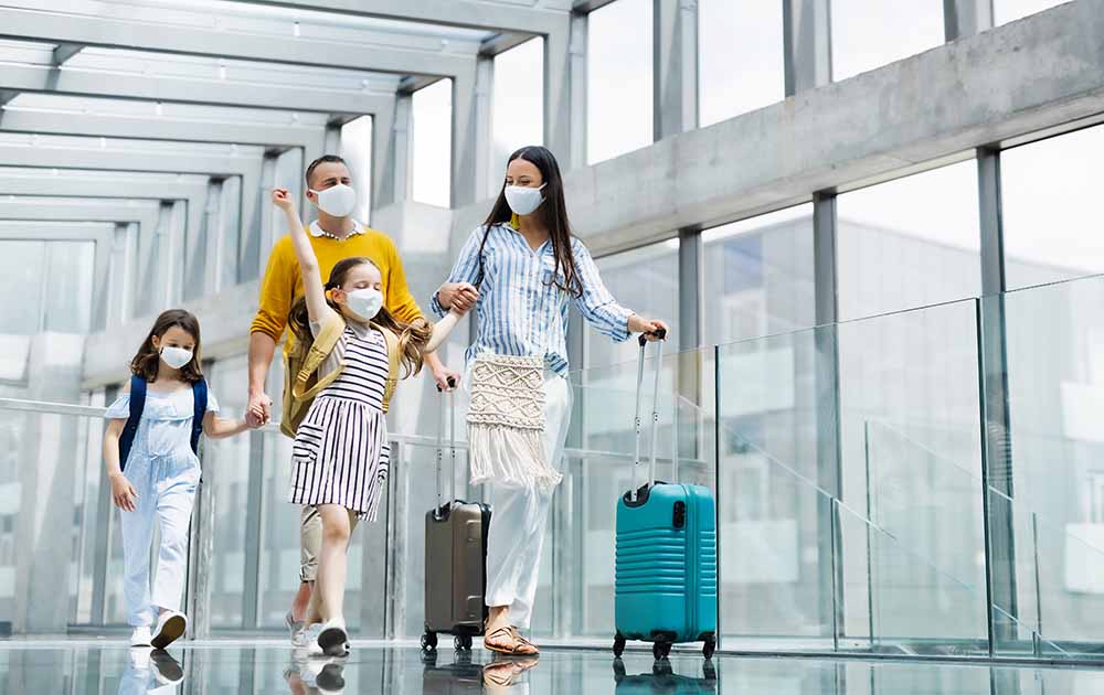 Family wearing face masks in an airport