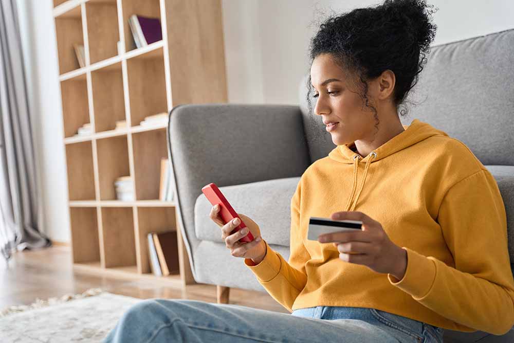 Jeune femme faisant des achats sur son téléphone intelligent